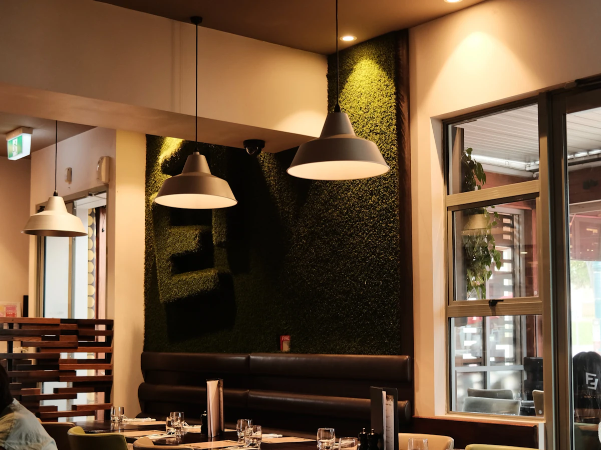 Warmly lit café interior with tables set for service